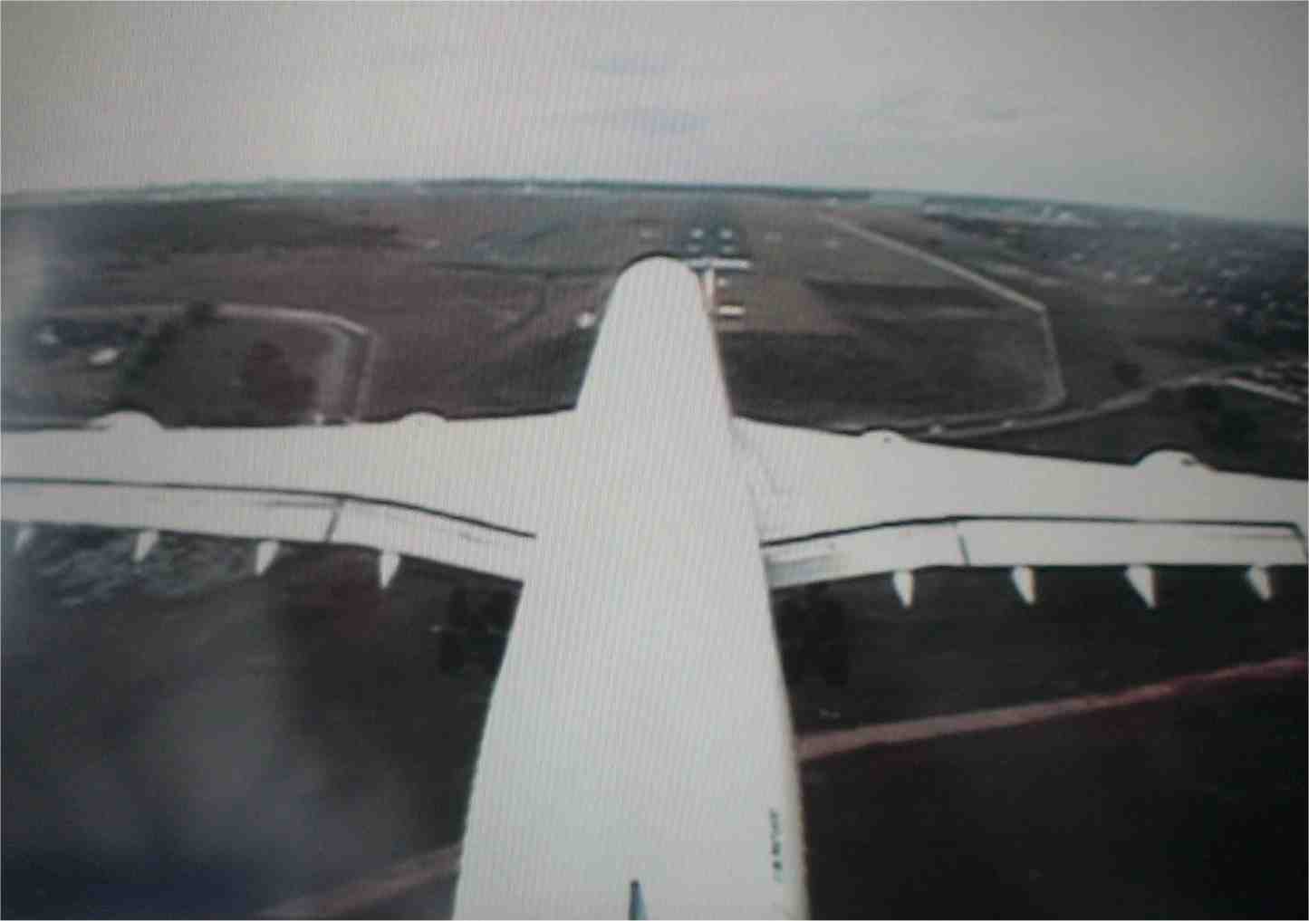This is a picture of my TV screen showing a video camera view of our plane as it's about to land, taken from the top of the tail. The runway can be seen just above the nose of the plane. Photo by FG.