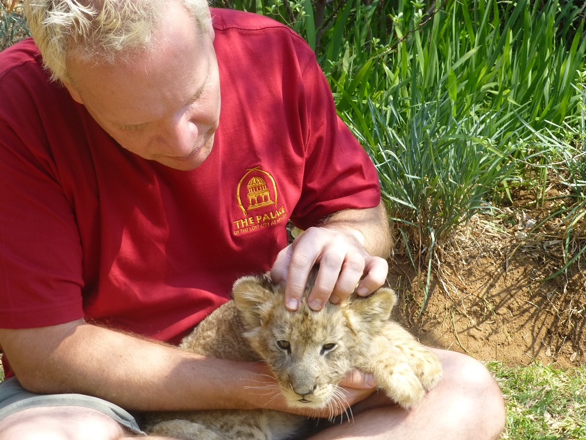 Tim petting lion cubs. Photo by FG.