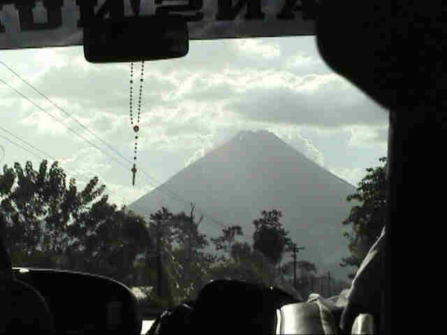 The Arenal Volcano seen through the windshield of our bus.  Photo by FG.