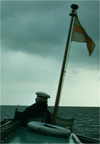 Captian Cornelius at the helm. Photo by FG.