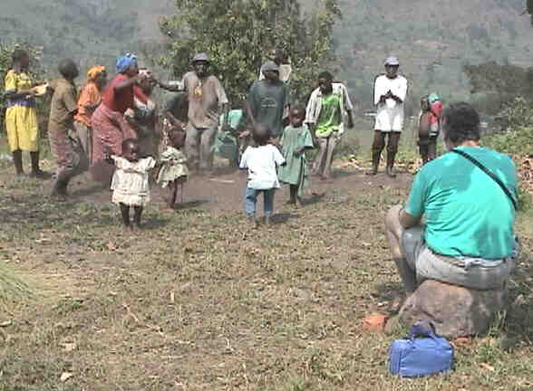 The pygmy dances and songs are pure delight.  Jungle Jim has a front-row seat.  The people exhibit such energy, enthusiasm, and spirit.  The little ones are particularly charming.  Photo by FG.